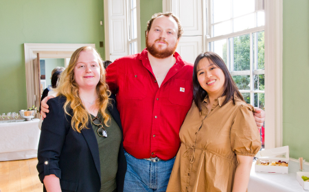 Three alumni posing for a photo at a reunion.